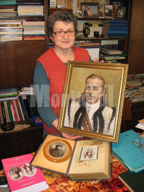 Elena Ienache cu portretul străbunicului Ioan Dugan-Opaiţ şi un vechi album de familie