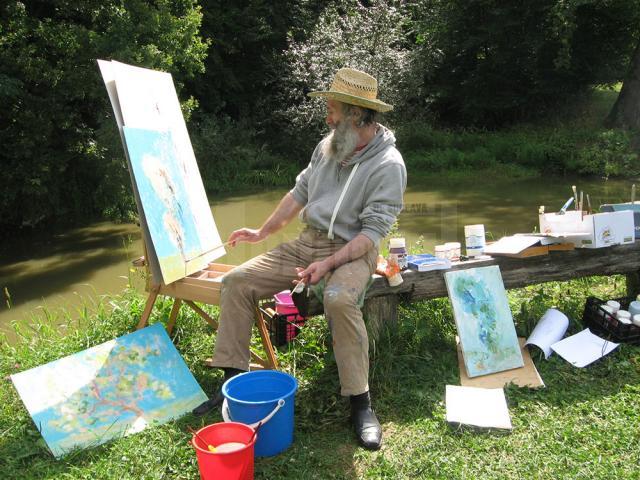 Mircea Dăneasă pictând pe malul iazului