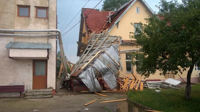 Acoperişul internatului unui liceu, aruncat de o tornadă la aproape 100 de metri, într-un bloc de locuinţe