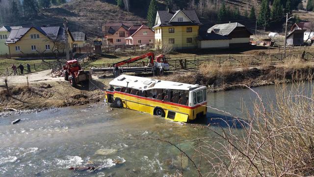Autobuzul a fost tras din apă cu ajutorul unui buldoexcavator