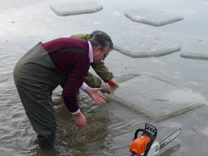 Gheața subţire a fost tăiată din iaz, urmând a lua forma crucilor pentru slujba Bobotezei