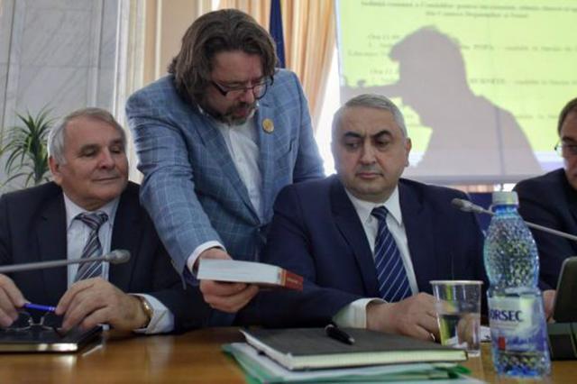 Senatorul USR Mihai Gotiu i-a dăruit rectorului o carte de gramatică la începutul audierilor. Foto: www.digi24.ro