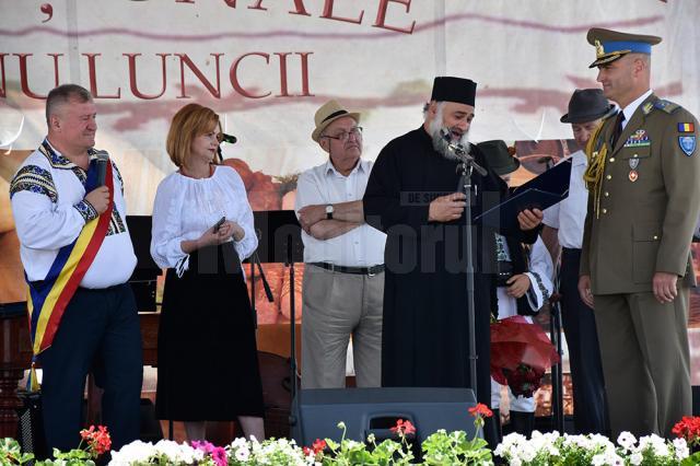 Preotul Florea citeşte decizia de acordare a titlului de Cetăţean de Onoare comandantului Cezar Cucoș
