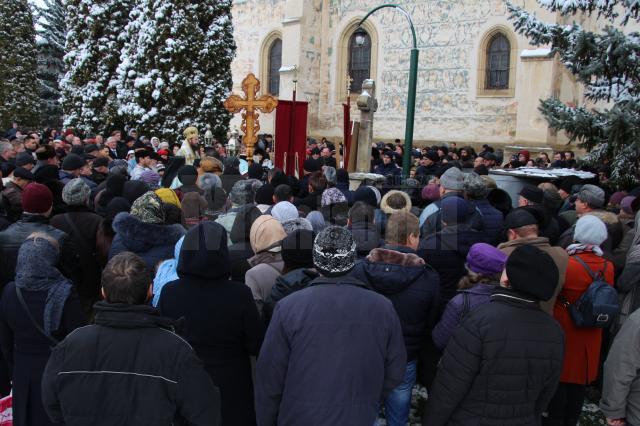 Sute de credinciosi in curtea manastirii Sf Ioan cel Nou de Boboteaza