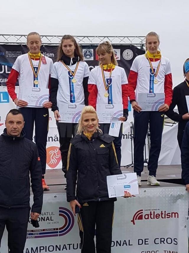 Antrenoarea Erzilia Țîmpău alături de sportivele sale, urcate pe cea mai înaltă treaptă a podiumului de premiere